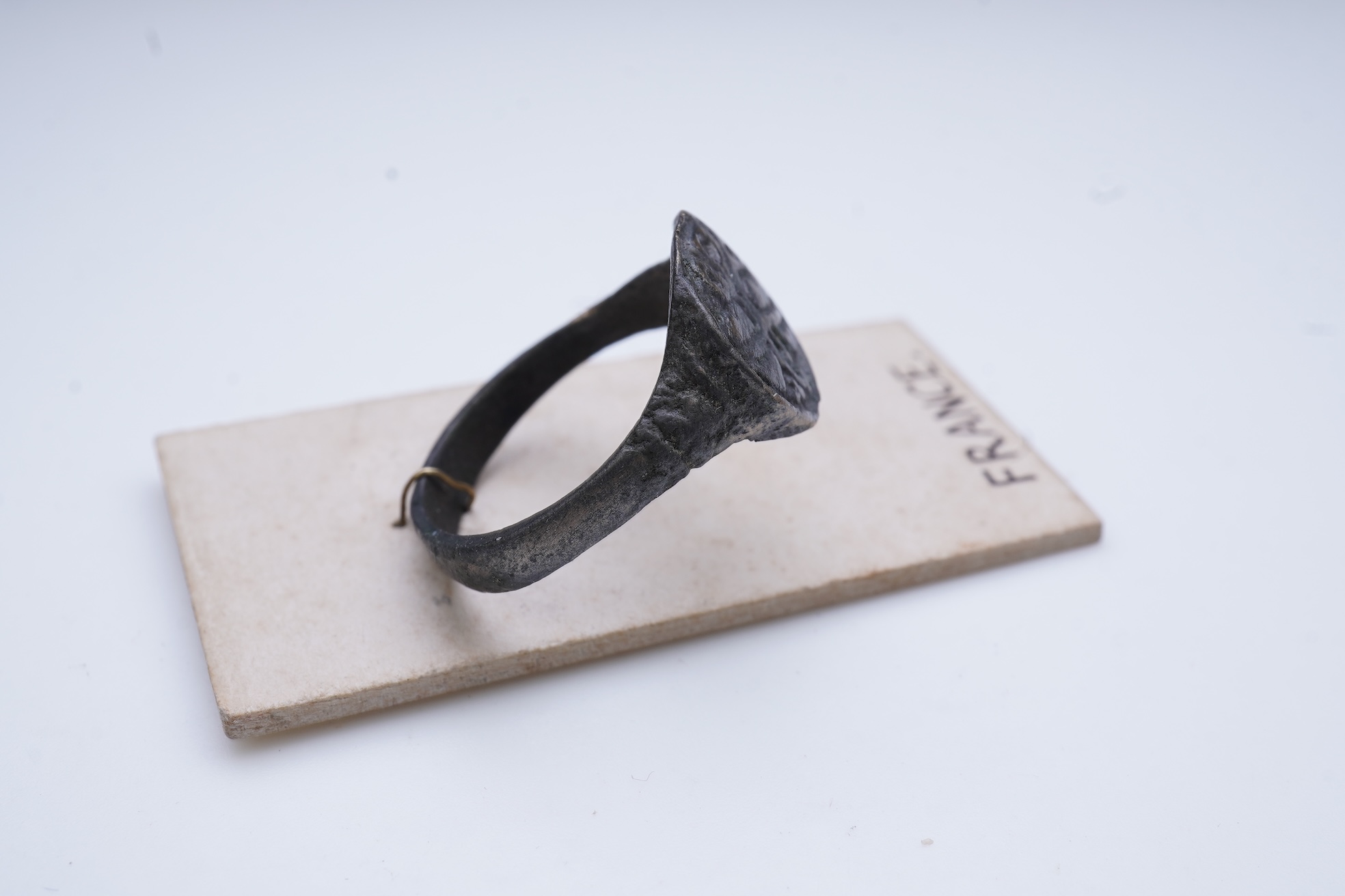 A sentimental signet ring, France, circa 16th century, the circular panel depicting two hearts tied in a true lover's knot, size R1/2, labelled 2244, Provenance: formerly in the collection of Dame Joan Evans (1893-1977)